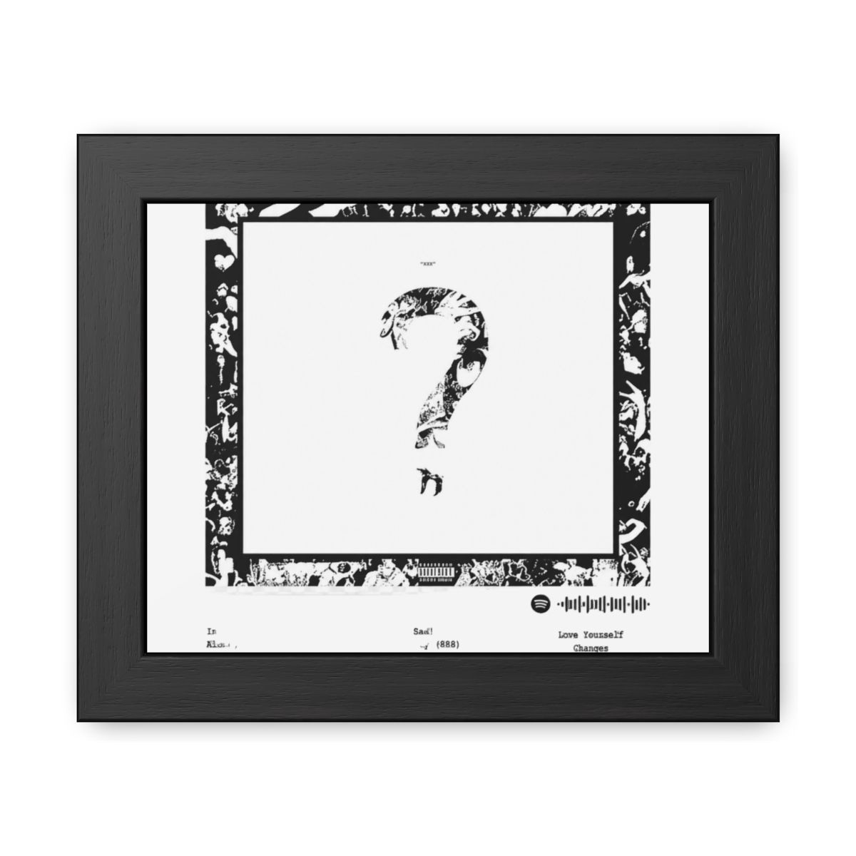 Black framed poster with the text "2018" and "XXXTENTACION". The poster features a large question mark graphic and a list of song titles. The background is white